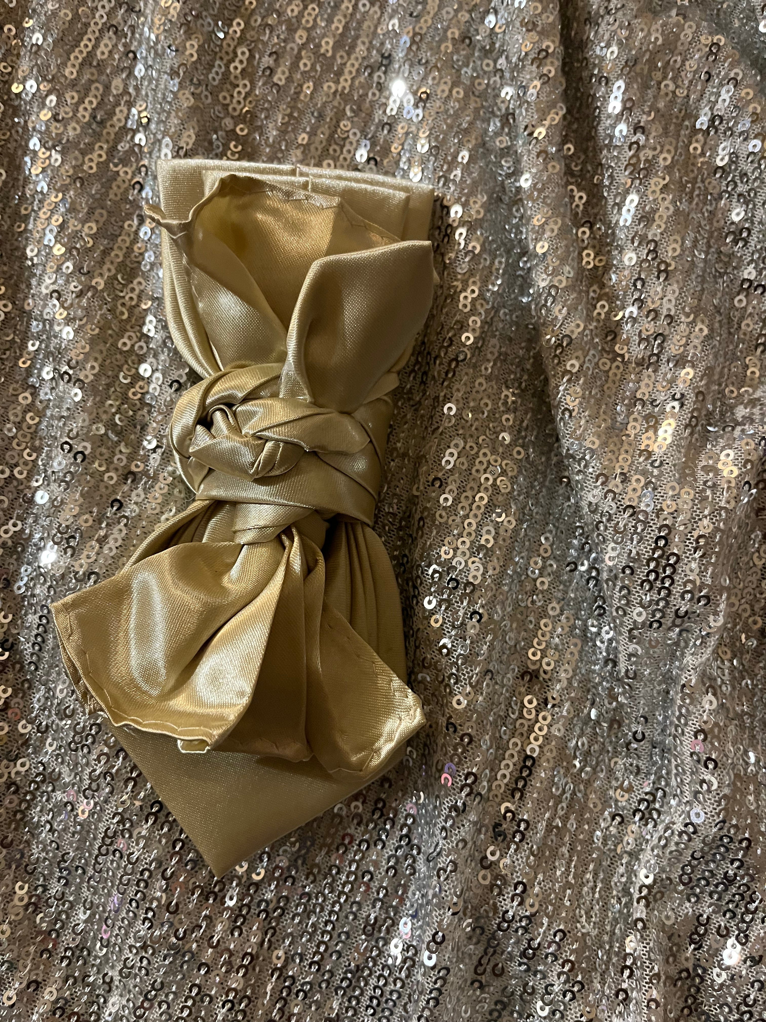 Gold Satin Luxe Tie with knotted bow detail on silver sequin backdrop